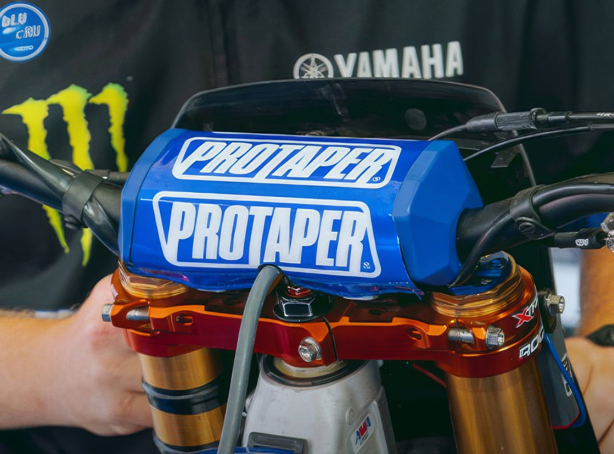 Close-up of a dirt bike handlebar with a ProTaper bar pad during a handlebar setup.