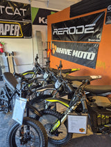 Row of Rerode electric dirt bikes on display under the Rerode and BHive Moto banners in the BHive Moto shop.