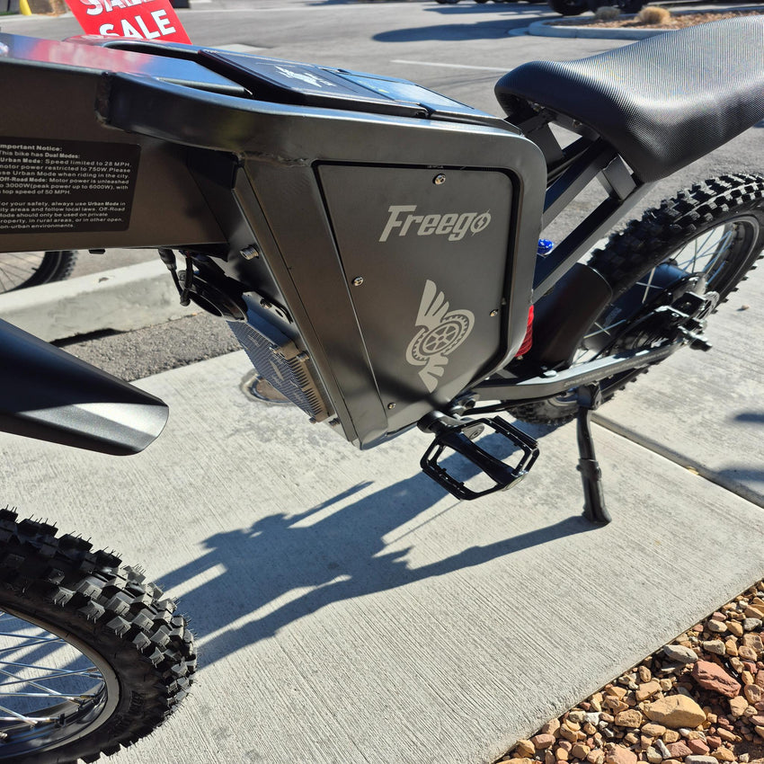 Freego X2 Pro electric dirt bike mid-section showing battery pack and frame