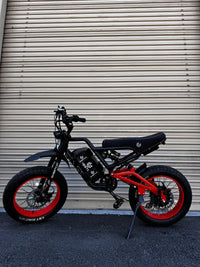 GhostCat Battery Strap shown on a black bike with red rims, full side view