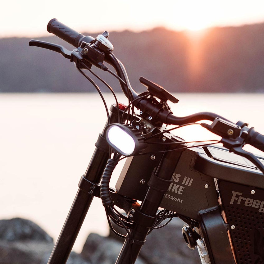 Freego Headlight for X2/X2 Pro, installed on an X2 at sunset by the water