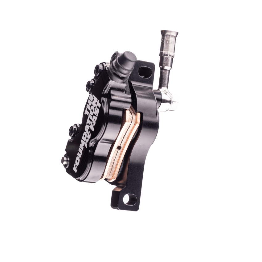 Formula EB7 front brake caliper detail – precision-machined alloy body with anodized finish