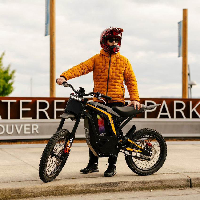 Freego Nova 4 electric dirt bike rider posing in front of a park sign