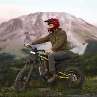 Freego Nova 4 electric dirt bike rider seated on a trail with mountain behind